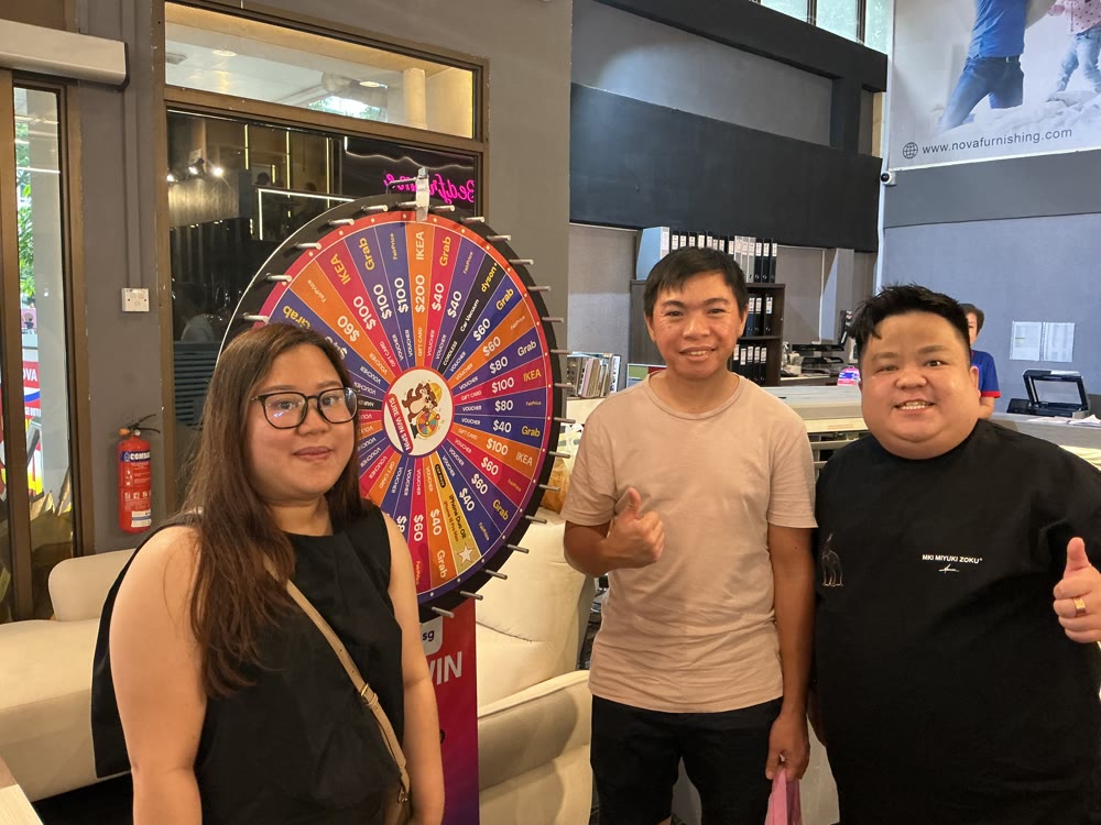 Homeowners giving a thumbs up at the lucky wheel