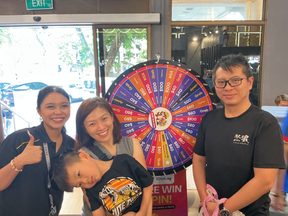 Homeowners smiling at the lucky wheel